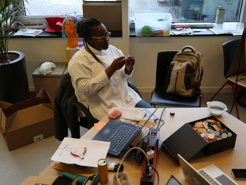 Team member sorting game components at the DSS studio